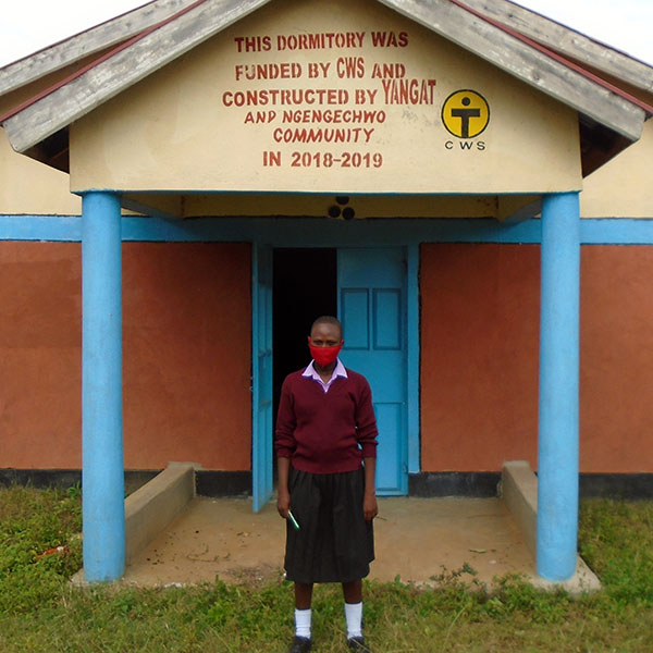 Delphine stands in front of the new dormitory