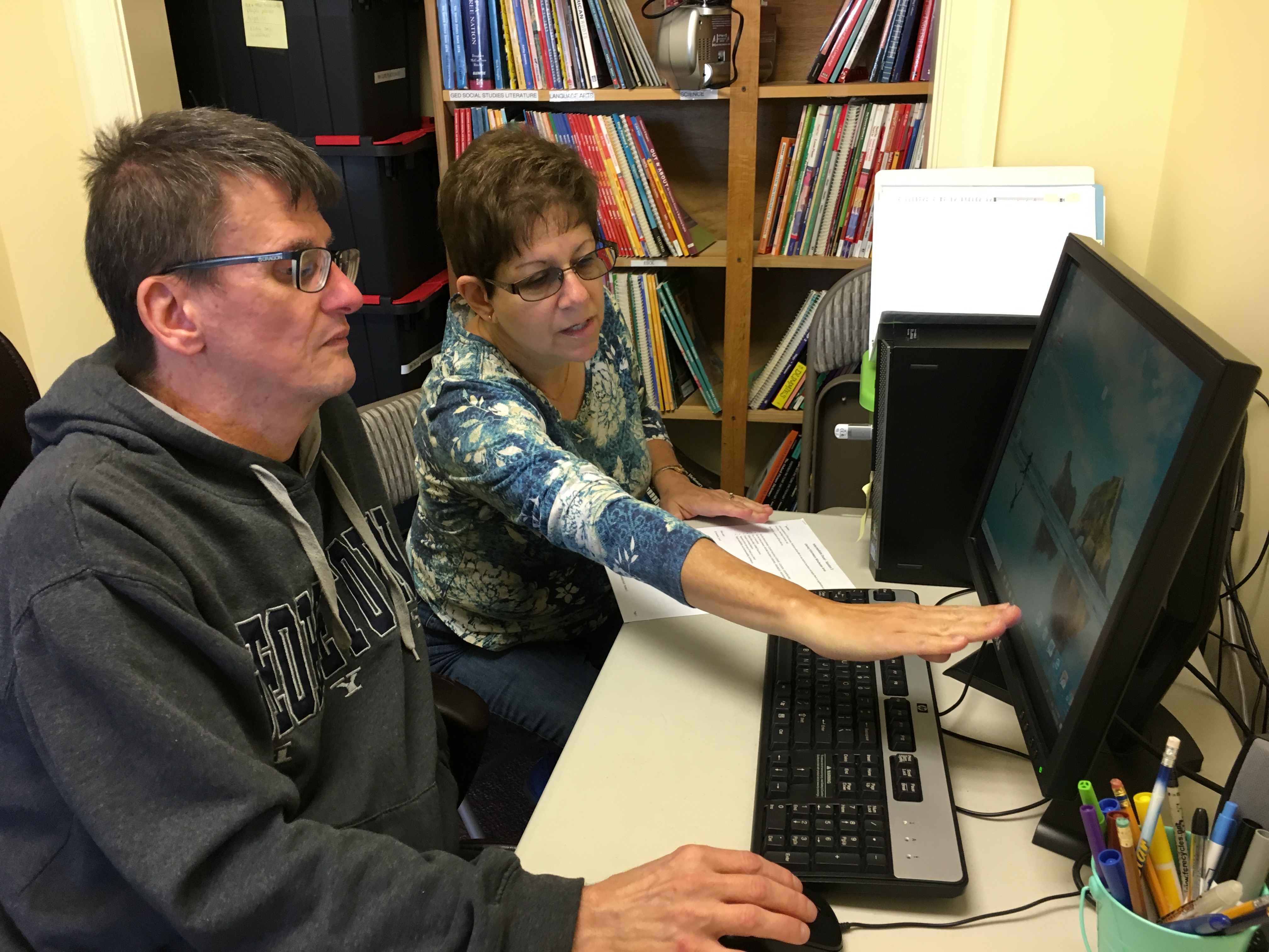 In person Tutor teaching a one-on-one Student computer class.