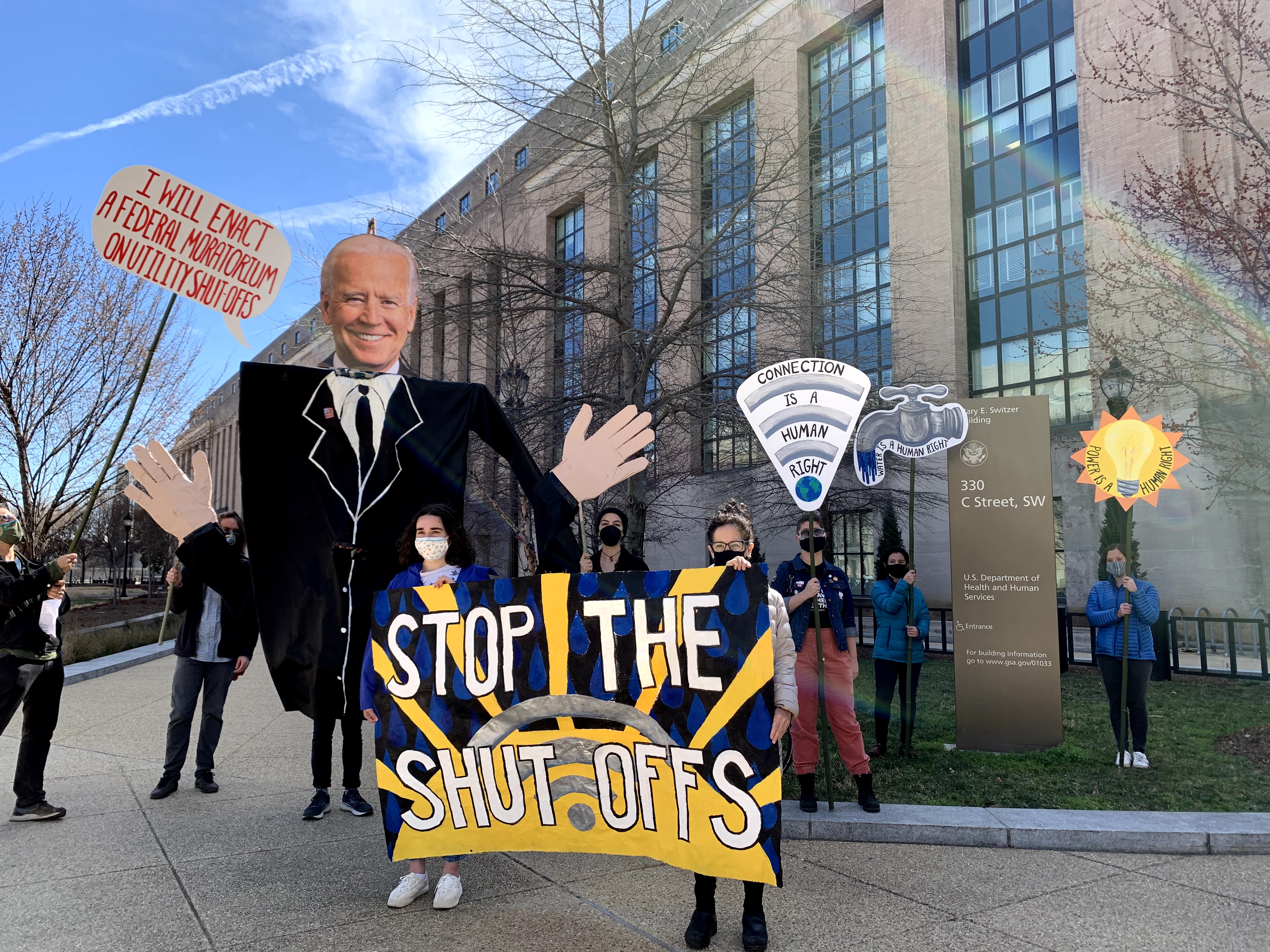 Food and Water Watch staff and activists rallying outside of the Health and Human Services building in DC on President Joe Biden’s 100th day in office, urging him to enact a federal moratorium on water, power, and broadband shutoffs.