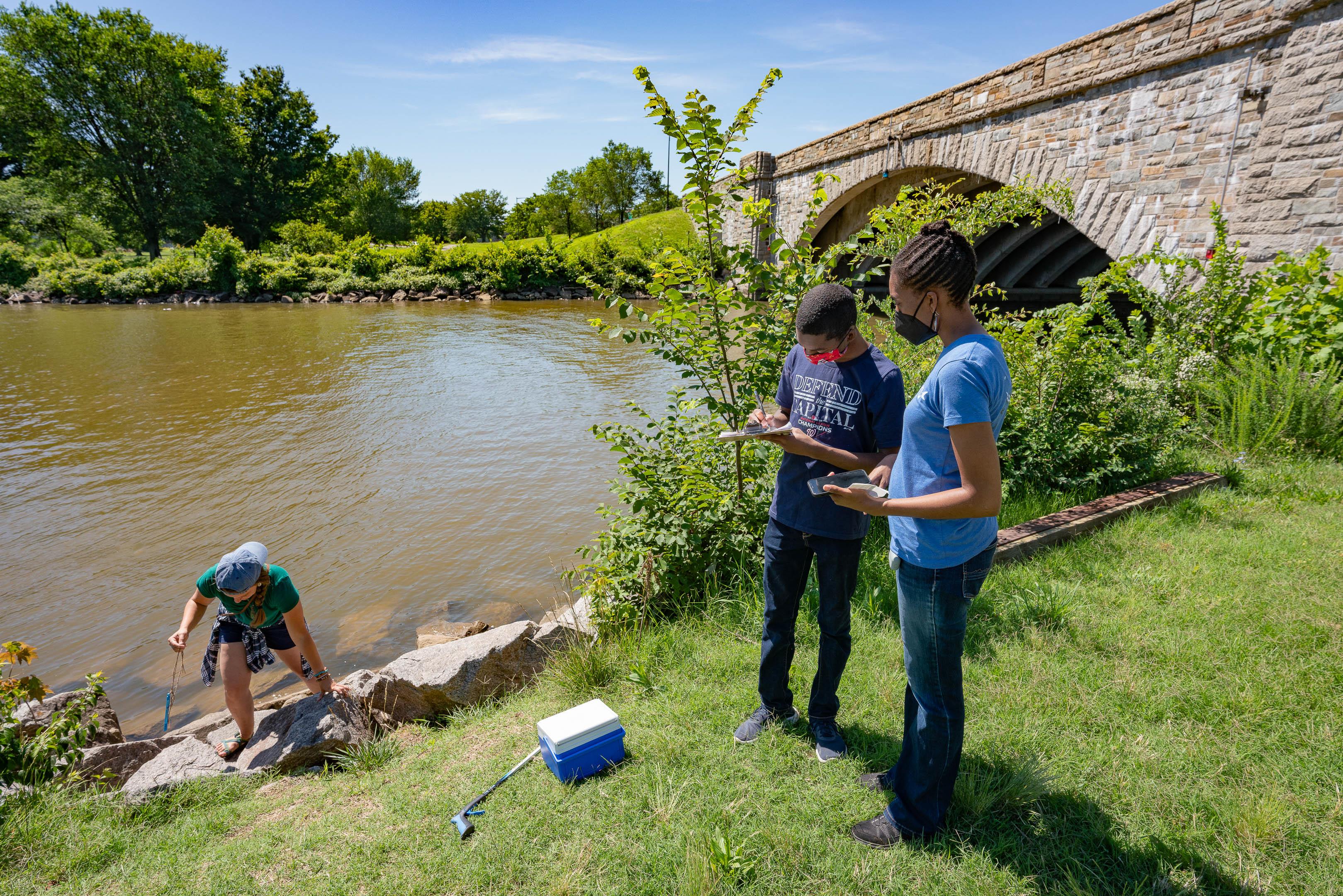 Two volunteers sample for PRKN's Community Science Water Quality Monitoring Program on the Potomac River.