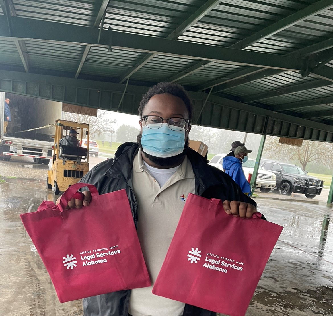 REIP Staff Attorney Donavon McGuire joined a Selma foodbank food give-away to help hand out meals and educate participants about LSA services.