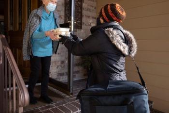 Julia recieves hot meals from a volunteer during the South Dakota winter