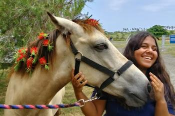 Boo gets love and attention from one his favorite people at Horses of Hope