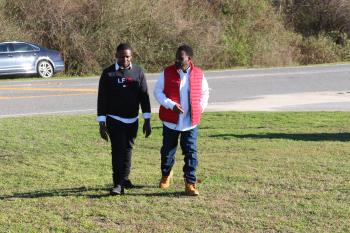 Kerry Robinson (right) and his son KyeSean walk side by side on the prison lawn moments after Kerry’s freedom from 18 years of wrongful imprisonment.