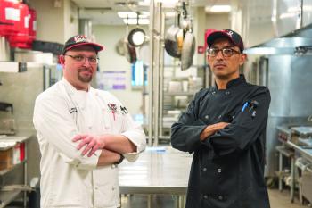 Chef Gregory S. Williams, MBA, CEC (left) and John Michael Johnson (right) posing in the Culinary Center kitchen for training