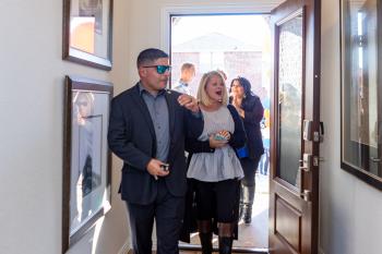 U.S. Army Captain John Arroyo and wife Angel enter their mortgage-free home for the first time thanks to Operation FINALLY HOME.  Photo Credit: Lennar Homes