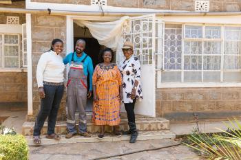 Leah (second from the right) and her family stand outside their rural Kenya home where they now have access to safe water year-round, thanks to donors like you.