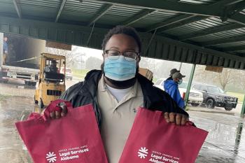 REIP Staff Attorney Donavon McGuire joined a Selma foodbank food give-away to help hand out meals and educate participants about LSA services.