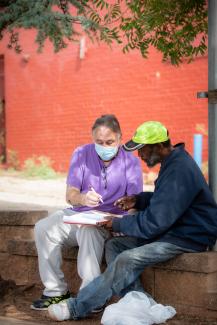 A member of the Street Outreach Team formed by a United Way Partner Agency works with a client on scheduling a medical appointment.